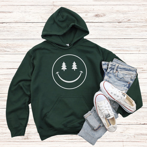 Introducing the latest in outdoor fashion and forest friendliness: the "Tree-mendous Smiles Hoodie"! This isn't just any hoodie; it's your ticket to becoming the most smiley face in the wild. With a dazzling happy face emblazoned on the front, you're set to spread joy among the trees, the birds, and even the most stubborn of rocks.
